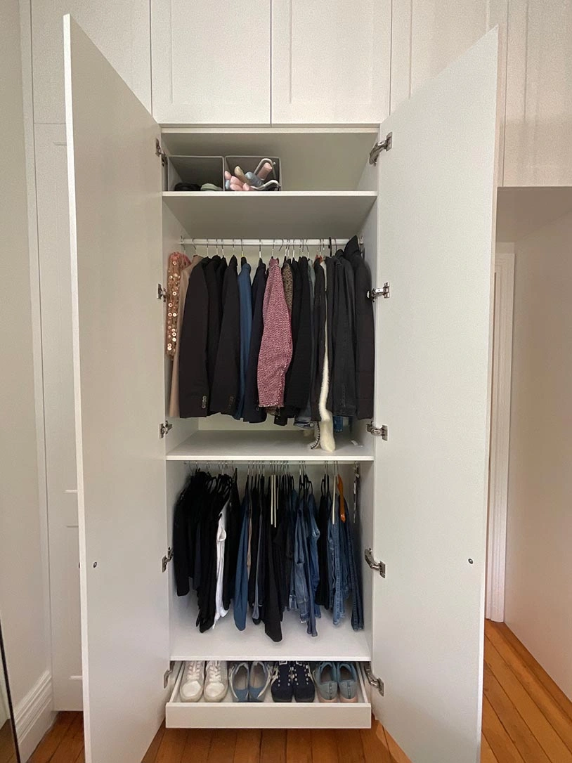 Spacious closet showcasing a variety of clothes and shoes